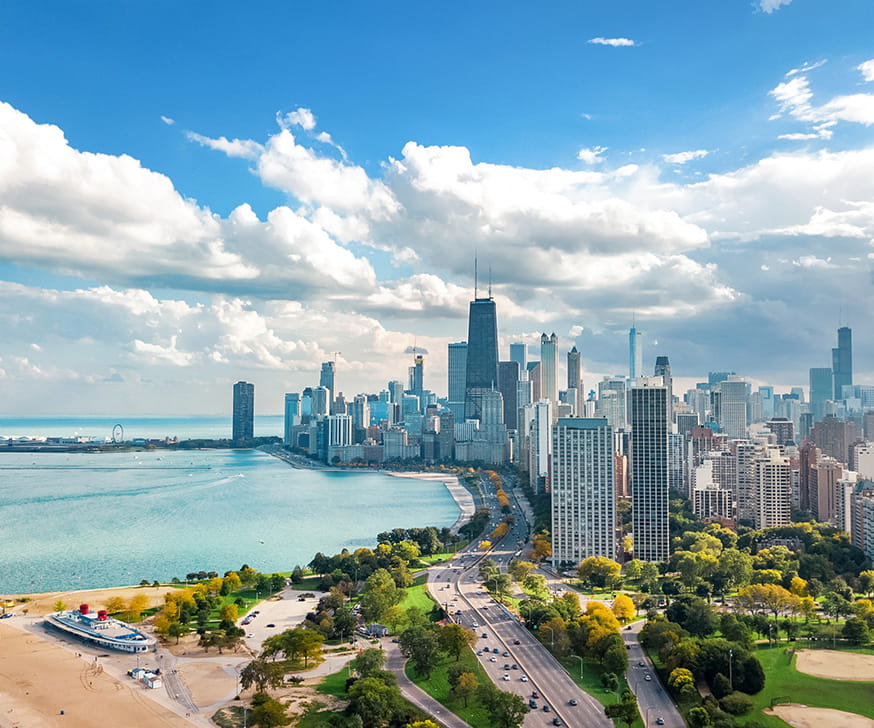 Sunny, blue sky day with view of downtown Chicago high rises, beaches, and lakefront
