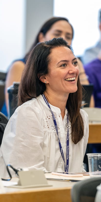 Woman smiling during class at the EMBA program at Kellogg