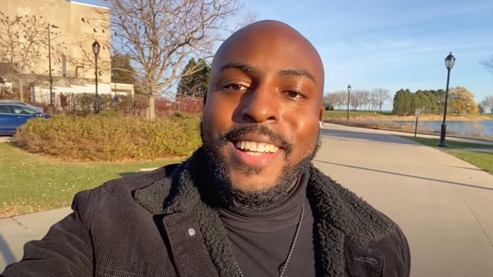 Guy recording a video about Kellogg MBA