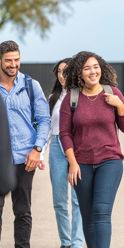 Students walking together outside and smiling