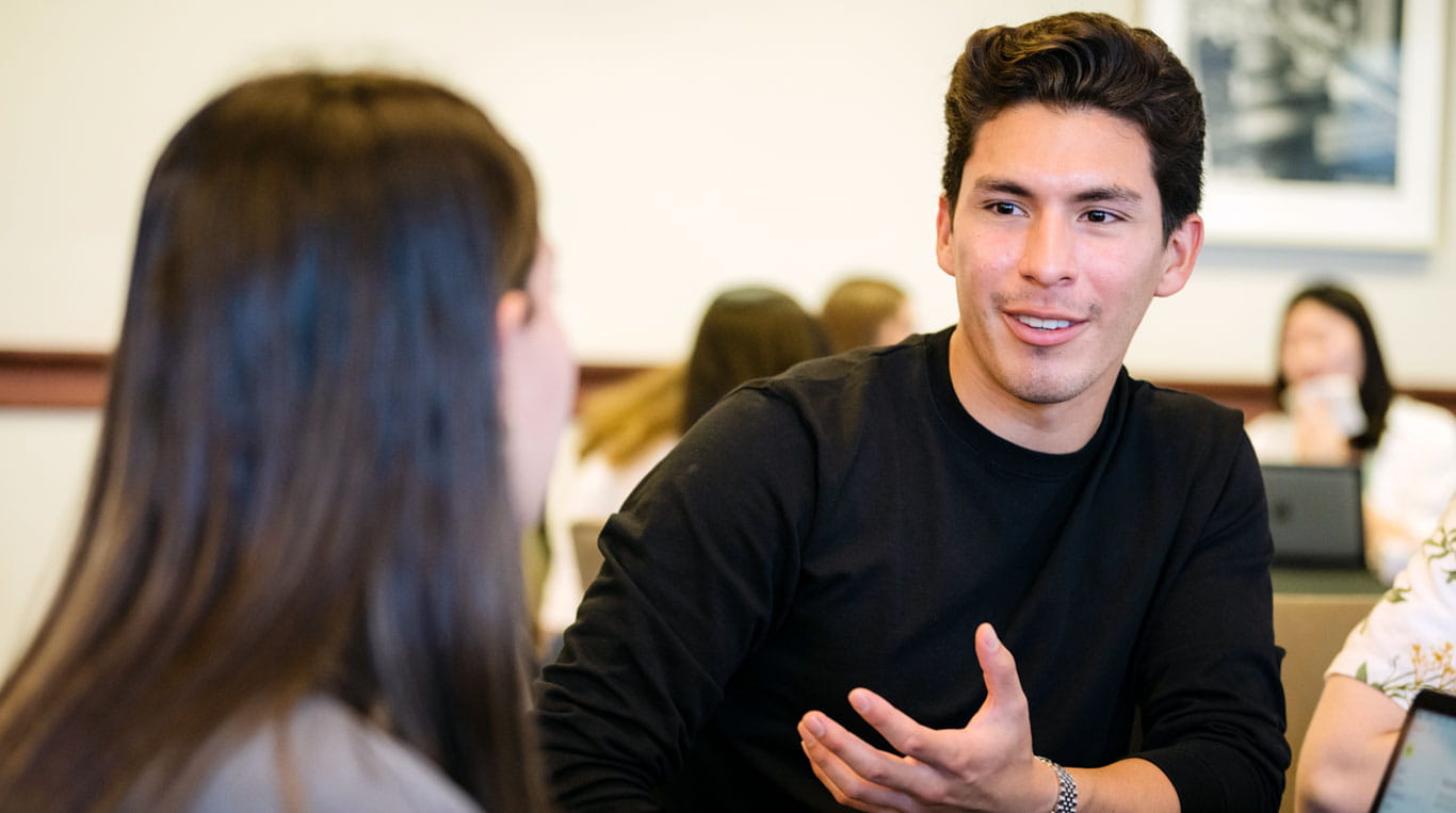 Two students in the MiM program talking before class.