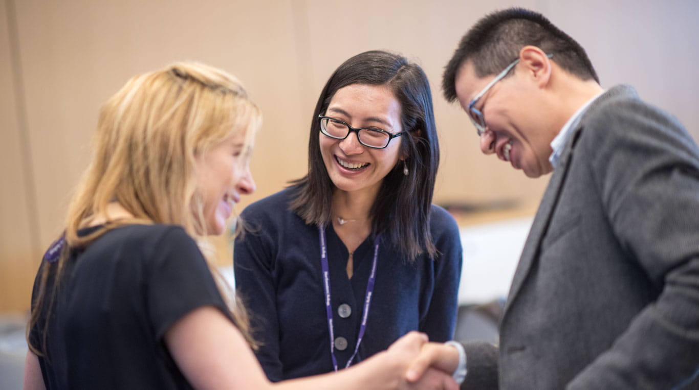 Two people shaking hands at Kellogg