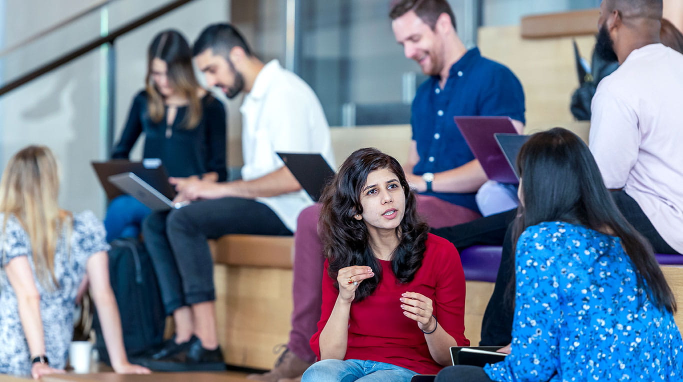 MBA students sit on the Spanish Steps of the Global Hub