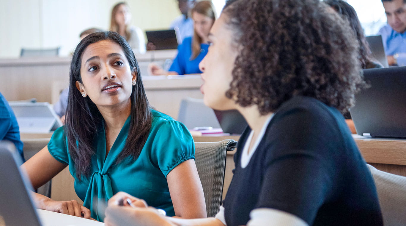 Kellogg MBA students discussing in a lecture hall