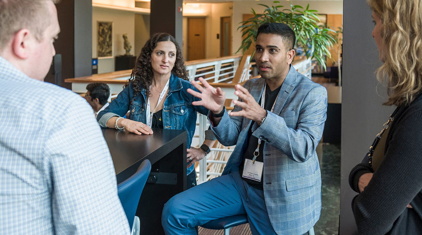 A group of Kellogg Executive MBA students in conversation together at the Allen Center
