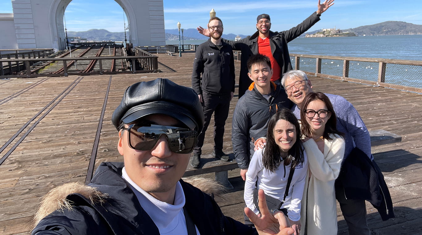 Kellogg Evening & Weekend MBA student and physician Federica Sidoti ’24 poses with friends and classmates from the Deep Dive course at an outing to a pier