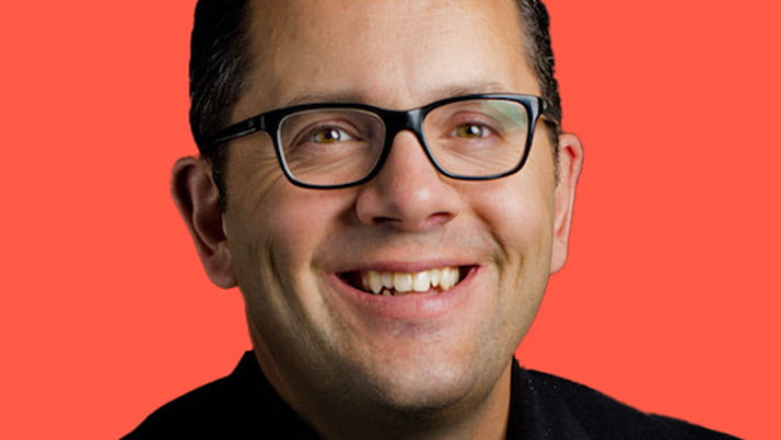 Photo of Small Wonder cofounder and Kellogg alumnus Paul Earle on a bright red background