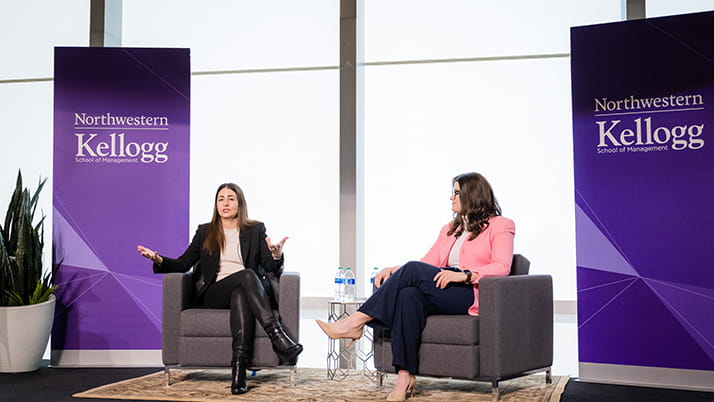 Liz Williams sits next to Kellogg MBA student Liz Willis and addresses a group of current business school students at the Global Hub.