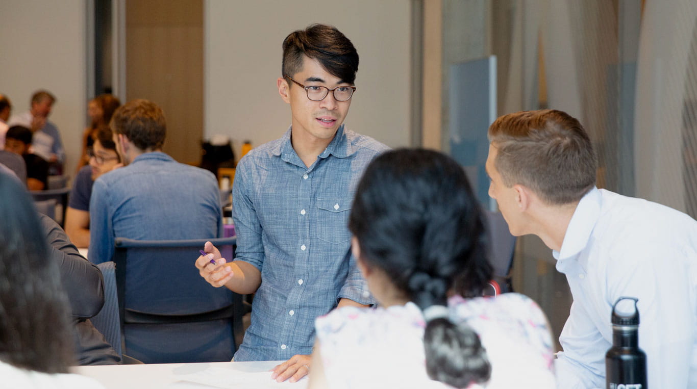 A Kellogg student in a classroom engaging with his peers to foster innovation.