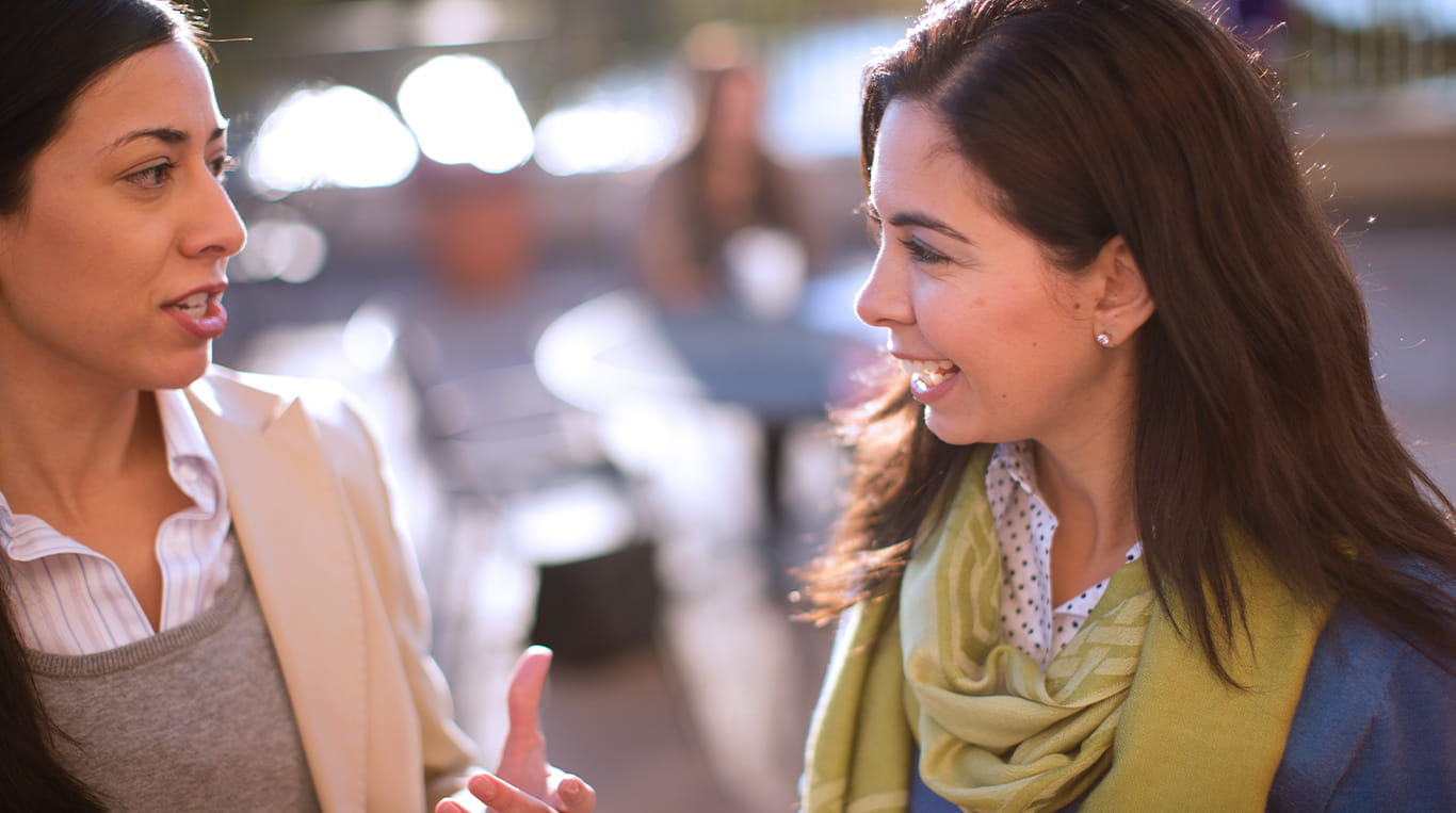 Two Kellogg students chatting with one another.
