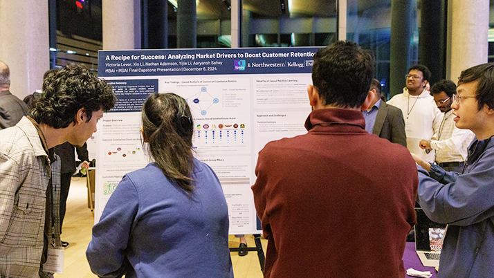 Attendees reviewing projects during the 2024 MBAi and MSAI capstone