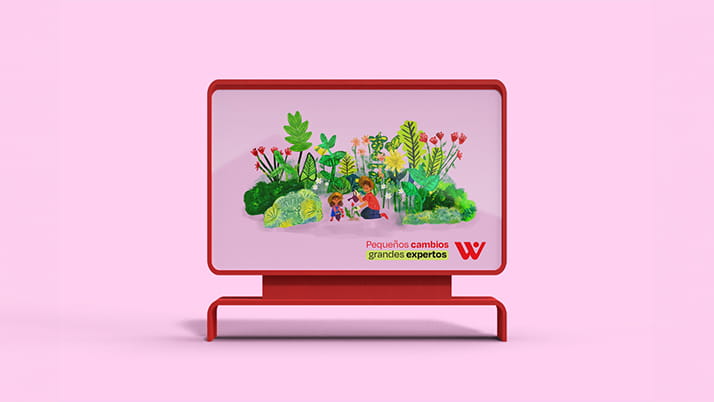 A billboard with an illustration of children exploring a lush, green garden, accompanied by the Spanish text 'Pequeños cambios, grandes expertos' and a red 'W' logo, set against a soft pink background.