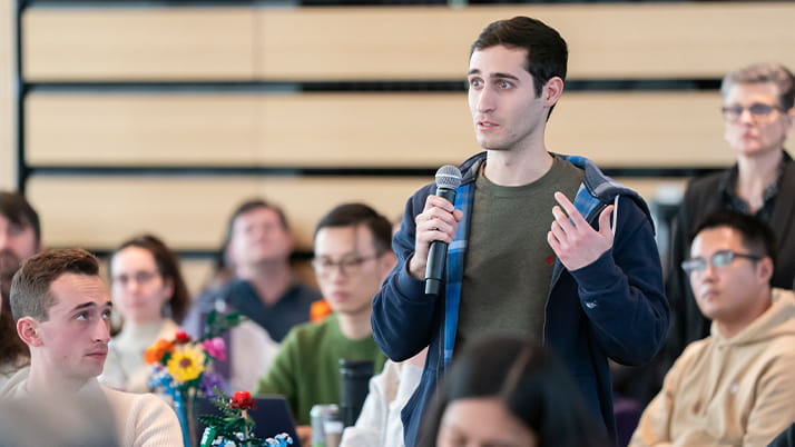 A Kellogg business student asking a question during a design event focused on creativity, innovation and business success