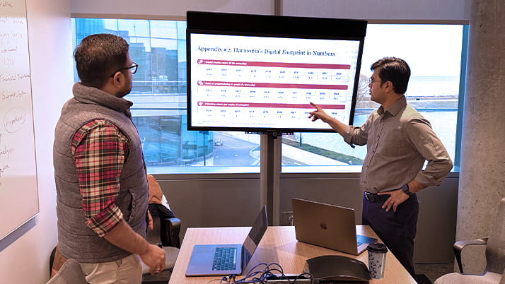 Two Kellogg MBA students analyzing data for their case competition