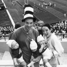 Peter '98 and Anna Harvey (MALS '98) introduced their three sons to football at Northwestern¹s 1999 Homecoming game. In hand are Robert, Mosby and William. 