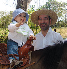 Antonio Enrique Dominguez — with dad Tony '88 and grandpa — saddles up at the ripe old age of 10 months.