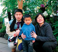 Lidan Yang '01 with husband David and son Lucas at the New York Botanical Garden