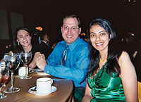 Sheela Chandrasekhara '01 celebrates the holidays in 2005 at a company Christmas party with Eric Kirr '01 and his wife, Beata '02.