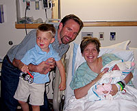 Jim Fields '02, wife Kiley and son Huck immediately after daughter Langley's birth.