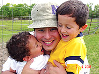 Santos Garza '02 enjoys his new home of Houston with his sons.