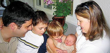 Arnaud Melin '02, Bastien, Ines and Florence all look at newest family member Amaury with joy.