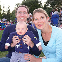 Rachel Wexler '03, husband Michael, and new son Gabriel smile from their lawn seats at this summer's Motley Crue/Ratt tour.