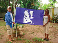 Coleman McDonough and girlfriend Deola raise the Northwestern flag in Nigeria.