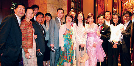 From left, Rony Mok '02, Cammy Yiu '02, Gary Wu '02, Lawrence Liu, Delphine Lee, Alvin So '02, Tammy Tam, Charles Yip '02, Fiona Chan '02, Priscilla Fong '02, Aquila Ho (groom), Winston Siu '02, Winnie Tsui, and Yuka Yeung gather to celebrate Priscilla's wedding.